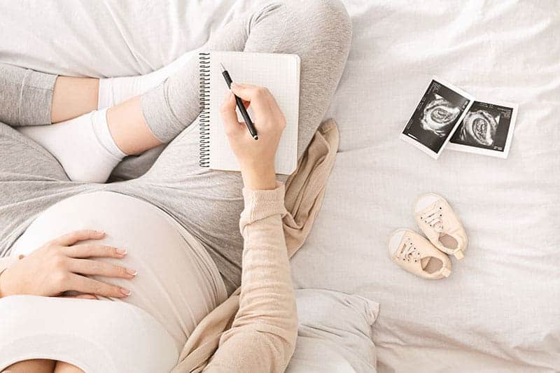 pregnant-woman-preparing-for-labor-sitting-on-bed